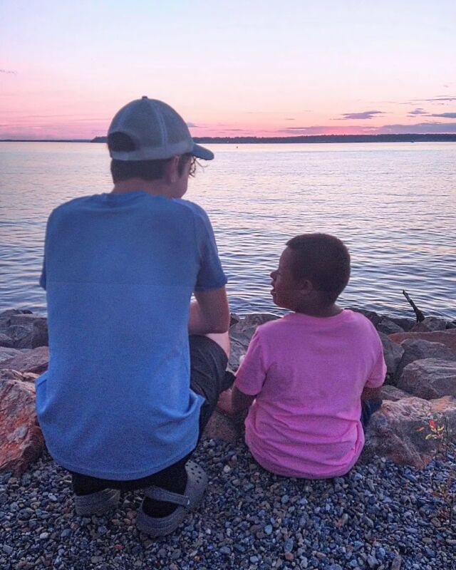 He's 15 now and officially taller than me.
I love who he is and who he's becoming.

But I miss 
his surprisingly deep toddler voice,
his giggle every time he said 'mommy,'
his dance routines in his tighty-whitey onesie,
his high-falsetto from the back seat
as we sang together 'Teach Me to Know' 
by #TheLoneBellow.

What a gift to celebrate this kid who has grown to embody empathy, humility, and kindness as he quietly serves and insists on the belonging of others. 

[ID: White boy with blue shirt and Brown boy with pink shirt are sitting on a rocky shore overlooking a large river at sunset.]

#Parenthood #HeyJude #RainbowBaby #GratefulMom